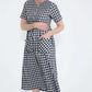 woman wearing a navy and white gingham print midi dress