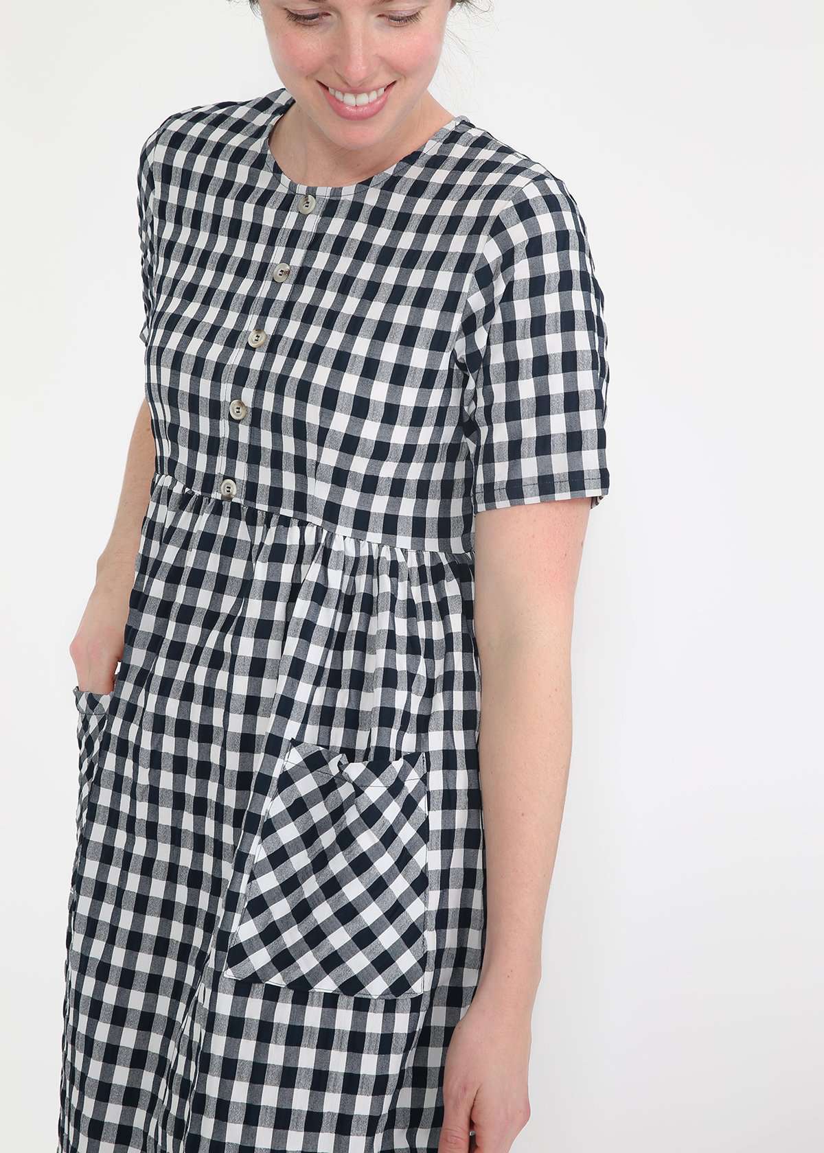 woman wearing a navy and white gingham print midi dress