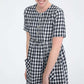 woman wearing a navy and white gingham print midi dress