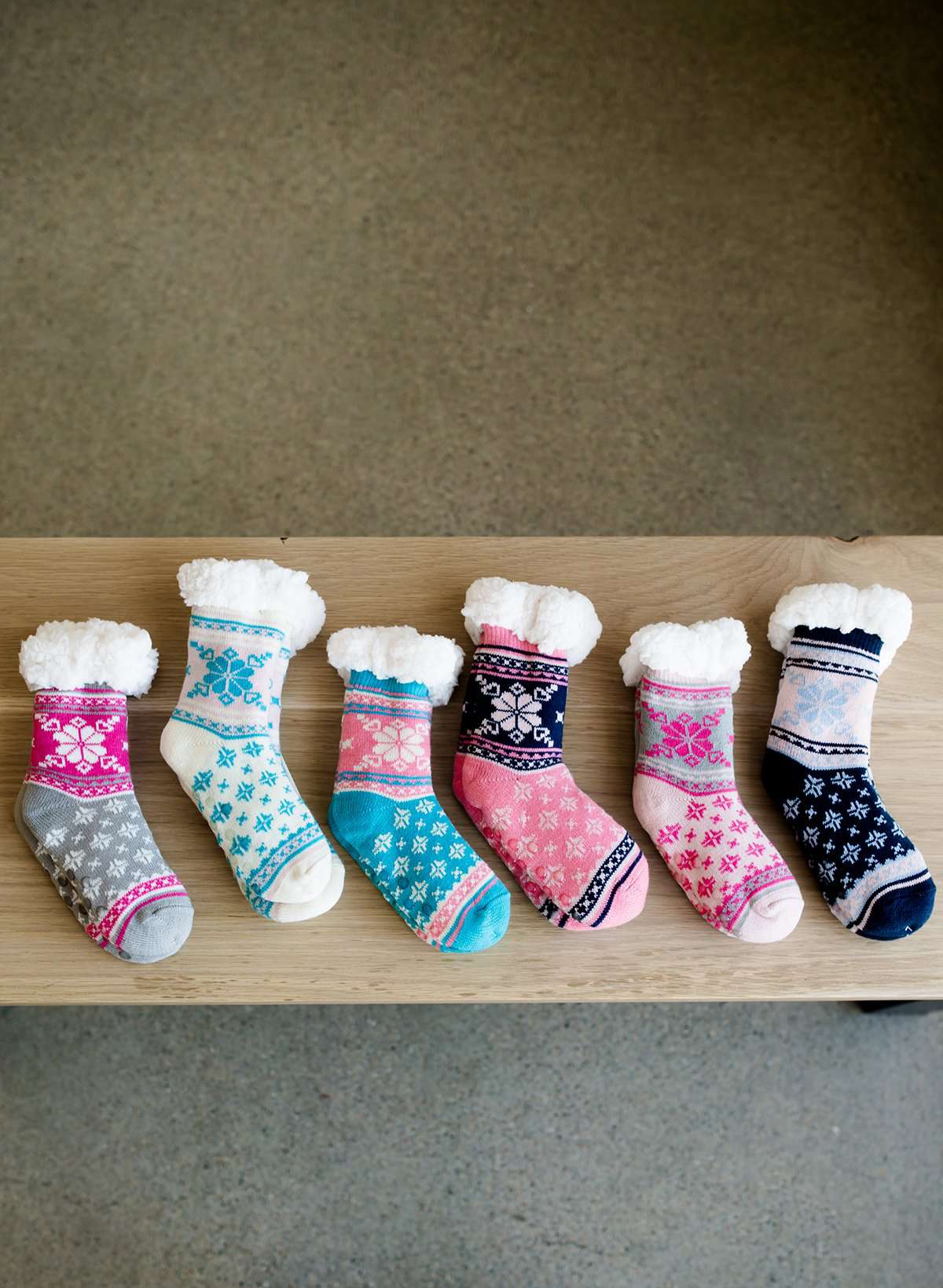 Snowflake slipper socks with skid proof bottoms. The come in blush, blue, cream, navy, pink and gray.