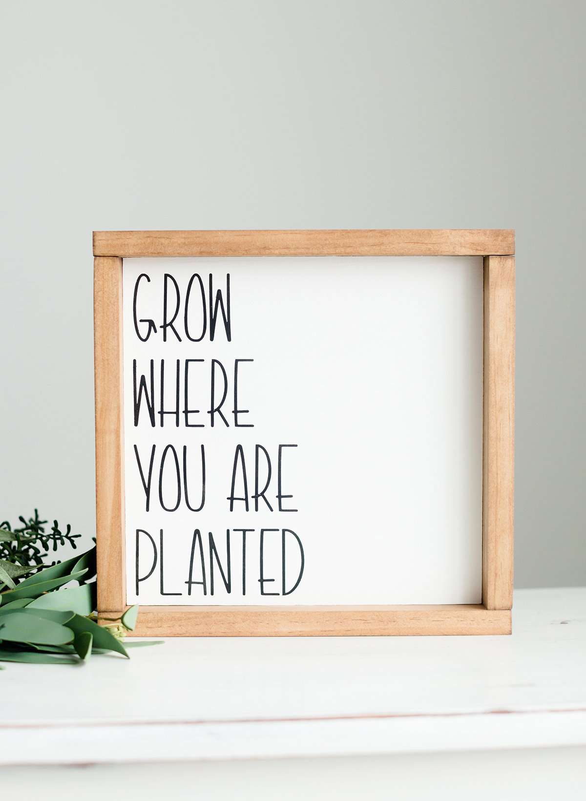 Woodframe Signboard that has script writing that says " Grow where you are planted".