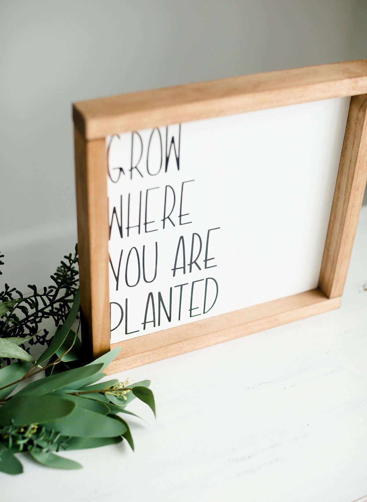 Woodframe Signboard that has script writing that says " Grow where you are planted".