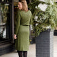 Woman wearing a olive colored hacci midi dress with a elastic waist and paired with black sole society boots