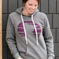 Triblend Minnesota hoodie on a young woman, the hoodie is navy with a gold MN emblem on front and gray with a purple MN emblem on front.