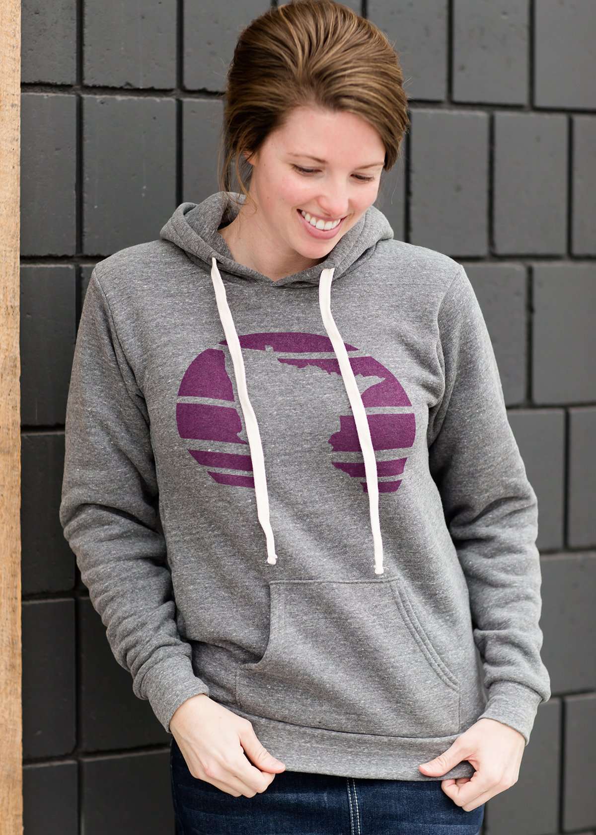 Triblend Minnesota hoodie on a young woman, the hoodie is navy with a gold MN emblem on front and gray with a purple MN emblem on front.