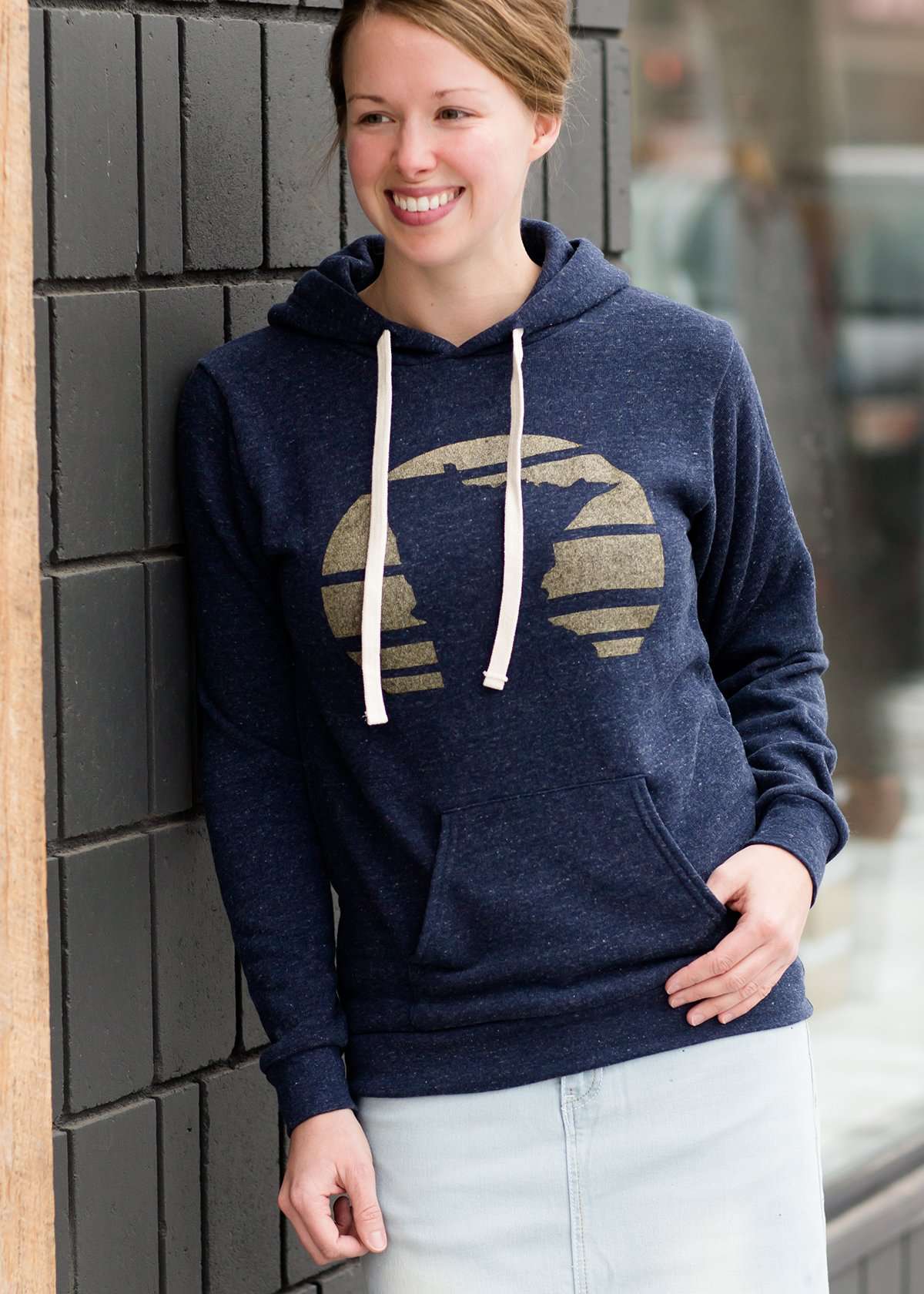 Triblend Minnesota hoodie on a young woman, the hoodie is navy with a gold MN emblem on front and gray with a purple MN emblem on front.