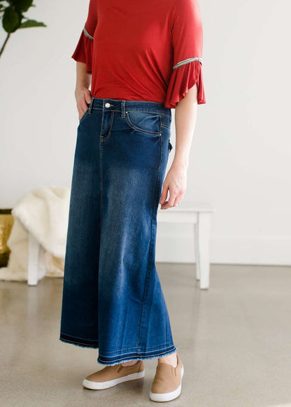 A-line long denim skirt with no slit and a raw edge hem.