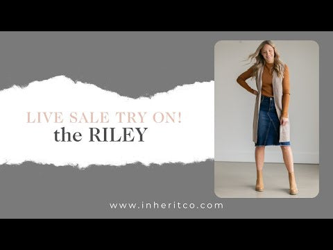 The Riley Frayed Hem Denim Midi Skirt is an Inherit Design that is full of lovely details! It is tailored in a slight a-line fit and super comfortable for anyone wanting that timeless look! This skirt is a darker wash with contrast stitching with a v-stitch in the front and back. You will love the raw bottom hem and the faux leather patch on the back!