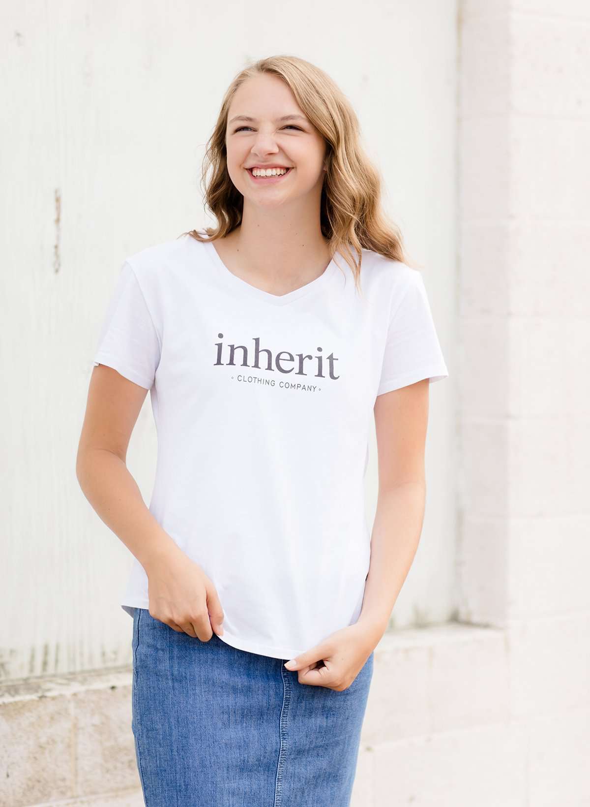 White modest v-neck t-shirt with inherit logo across the chest.
