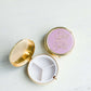 Round purple, mary square pill case with three compartments.