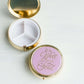 Round purple, mary square pill case with three compartments.