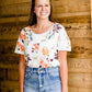 Modest cream tee with multi-colored floral detail 
