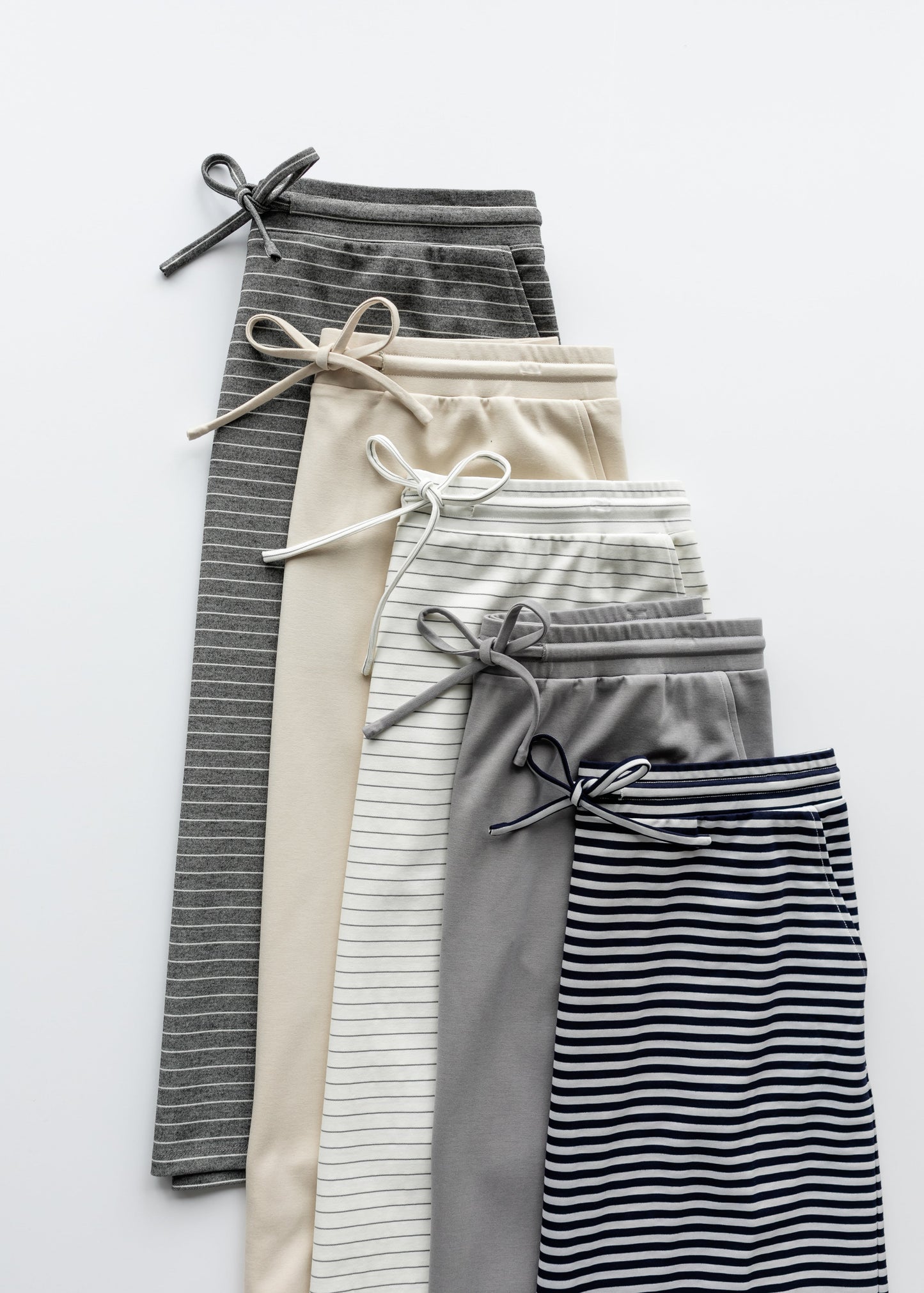 A modest gray midi skirt with white stripes. Featuring a a straight fit, pockets, and a drawstring waist.