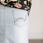 Young lady wearing a light denim below the knee jean skirt.