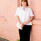 Woman wearing a straight style, ultra soft versatile black midi skirt.