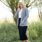 Woman wearing a straight style, ultra soft versatile black midi skirt.