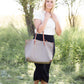 Woman wearing a straight style, ultra soft versatile black midi skirt.