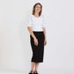 Woman wearing a straight style, ultra soft versatile black midi skirt.