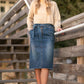 This midi length skirt is made out of stretch denim, with a paperbag stretch waist, with a matching belt, and a raw hem.