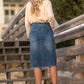 This midi length skirt is made out of stretch denim, with a paperbag stretch waist, with a matching belt, and a raw hem.