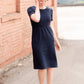 Meet Kristen. This Short sleeve Midi Dress was designed in-house and definitely isn't your typical cotton midi dress! This classic style is crafted with quality fabrics and needs no slip. The elastic waist and longer, short sleeves are extremely flattering and feminine. You will also love the placement of the two front pockets as well, this small patch style pocket hits just right!
