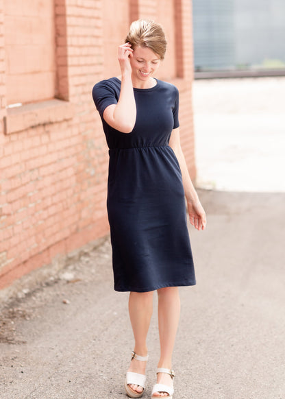 Meet Kristen. This Short sleeve Midi Dress was designed in-house and definitely isn't your typical cotton midi dress! This classic style is crafted with quality fabrics and needs no slip. The elastic waist and longer, short sleeves are extremely flattering and feminine. You will also love the placement of the two front pockets as well, this small patch style pocket hits just right!