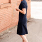 Meet Kristen. This Short sleeve Midi Dress was designed in-house and definitely isn't your typical cotton midi dress! This classic style is crafted with quality fabrics and needs no slip. The elastic waist and longer, short sleeves are extremely flattering and feminine. You will also love the placement of the two front pockets as well, this small patch style pocket hits just right!