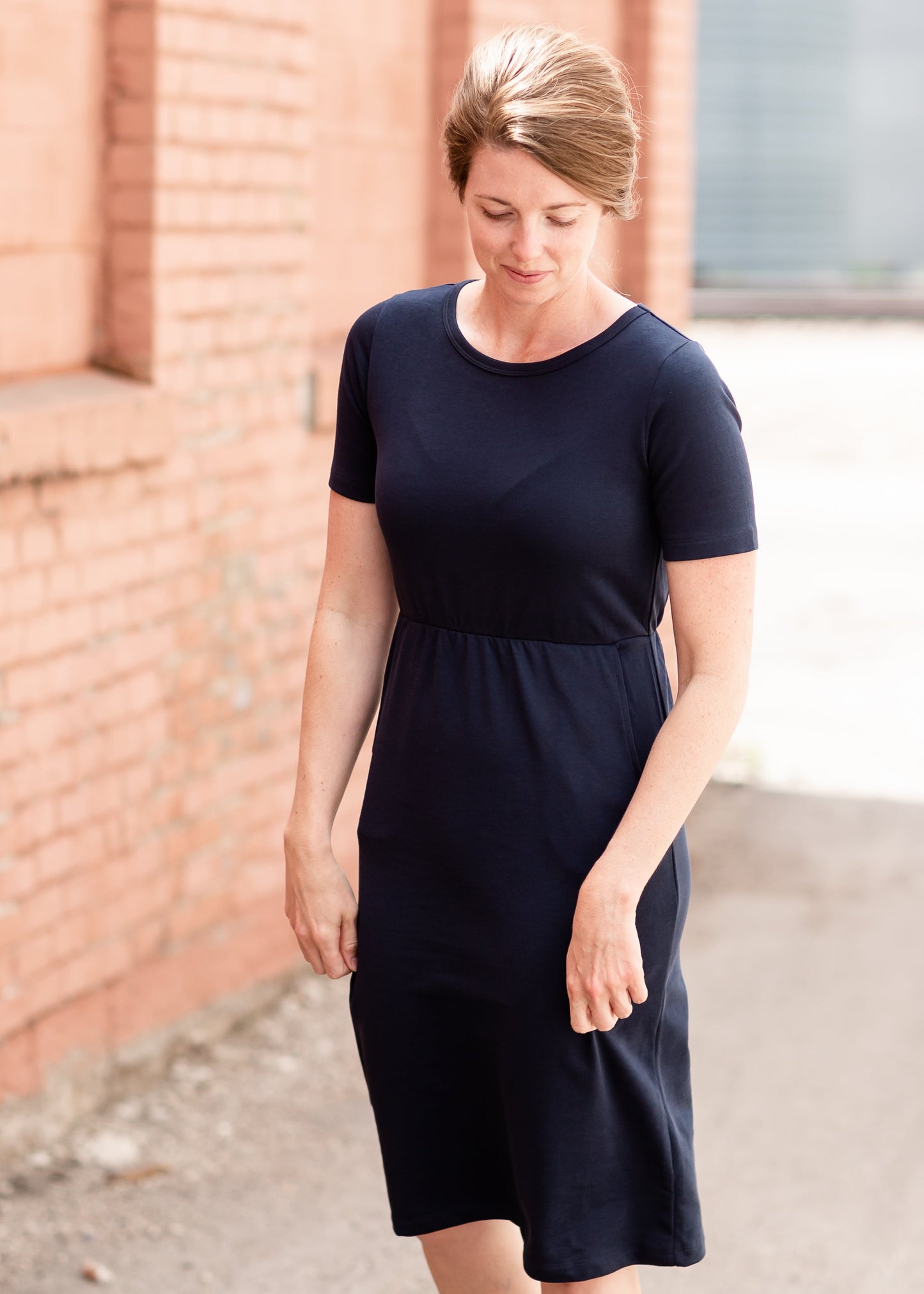 Meet Kristen. This Short sleeve Midi Dress was designed in-house and definitely isn't your typical cotton midi dress! This classic style is crafted with quality fabrics and needs no slip. The elastic waist and longer, short sleeves are extremely flattering and feminine. You will also love the placement of the two front pockets as well, this small patch style pocket hits just right!