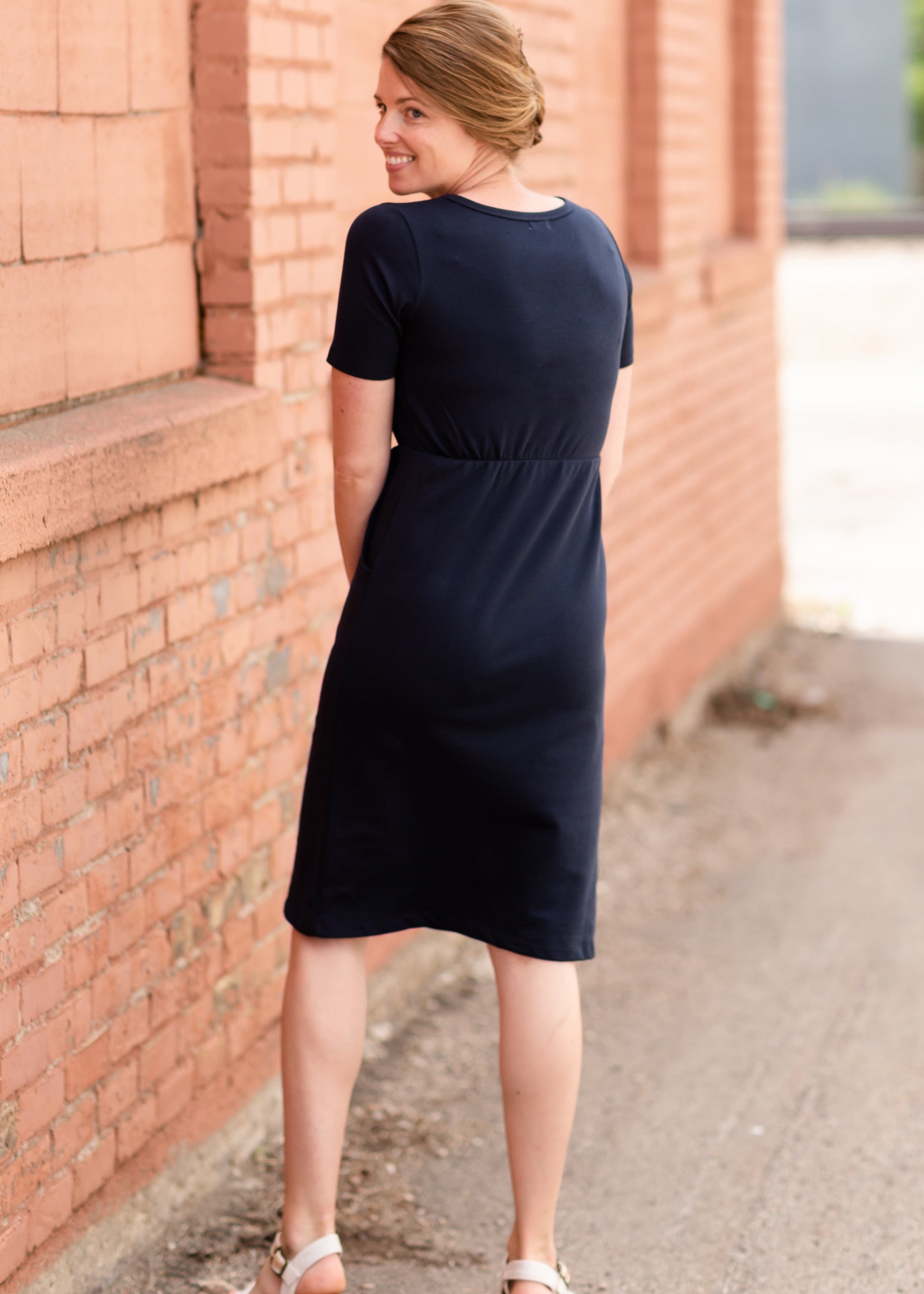Meet Kristen. This Short sleeve Midi Dress was designed in-house and definitely isn't your typical cotton midi dress! This classic style is crafted with quality fabrics and needs no slip. The elastic waist and longer, short sleeves are extremely flattering and feminine. You will also love the placement of the two front pockets as well, this small patch style pocket hits just right!