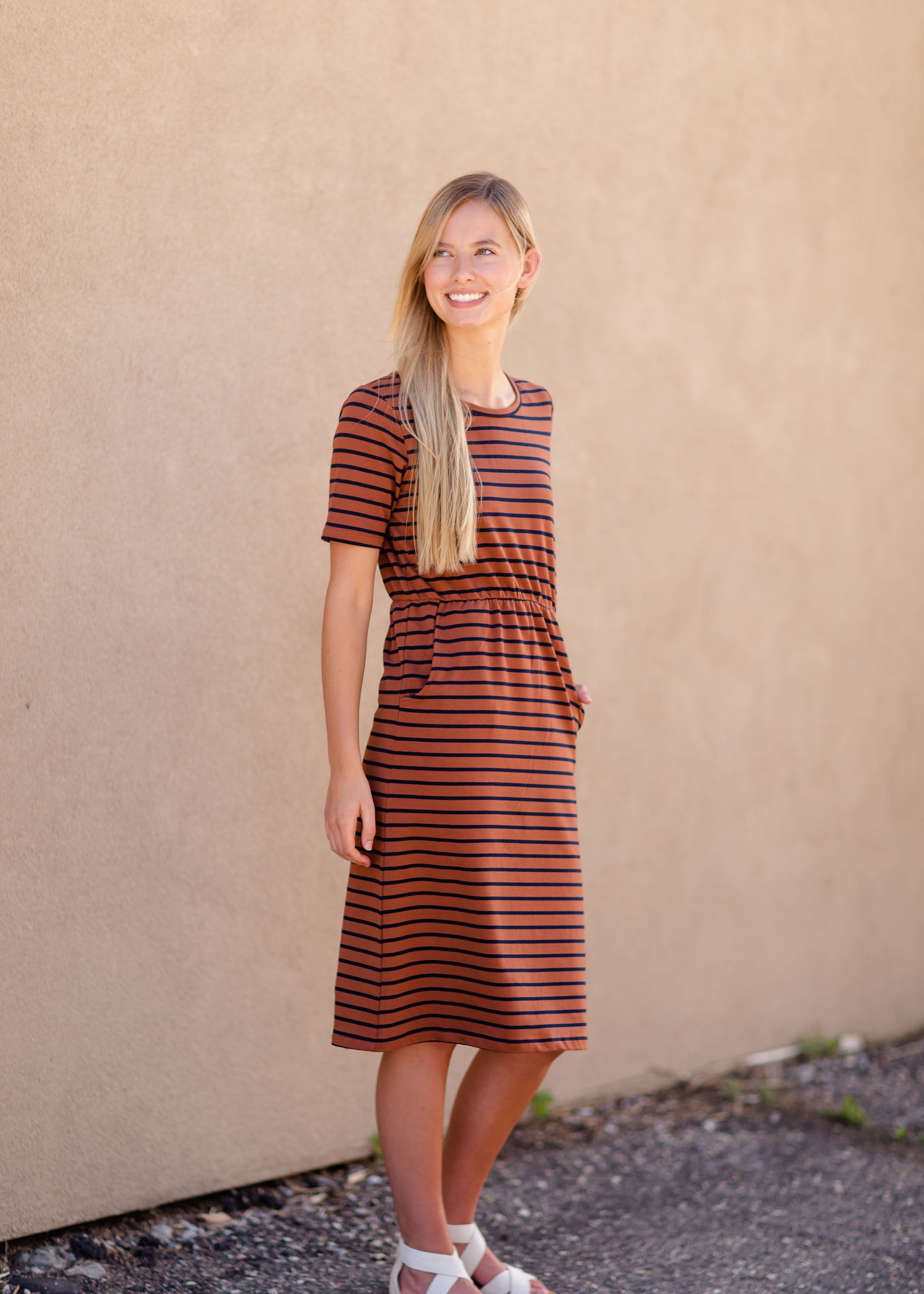 Meet Kristen. This Short sleeve Midi Dress was designed in-house and definitely isn't your typical cotton midi dress! This classic style is crafted with quality fabrics and needs no slip. The elastic waist and longer, short sleeves are extremely flattering and feminine. You will also love the placement of the two front pockets as well, this small patch style pocket hits just right!
