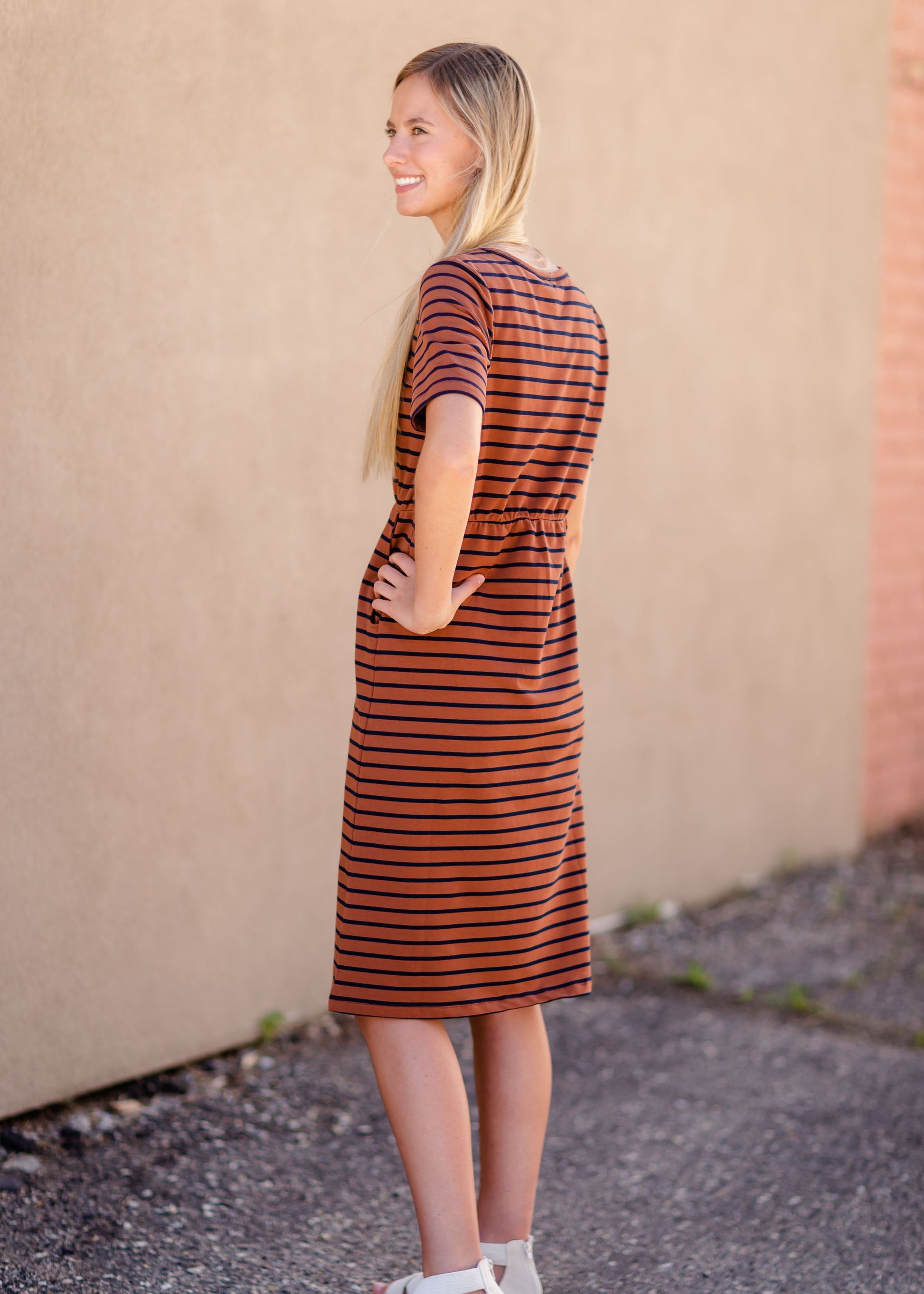 Meet Kristen. This Short sleeve Midi Dress was designed in-house and definitely isn't your typical cotton midi dress! This classic style is crafted with quality fabrics and needs no slip. The elastic waist and longer, short sleeves are extremely flattering and feminine. You will also love the placement of the two front pockets as well, this small patch style pocket hits just right!