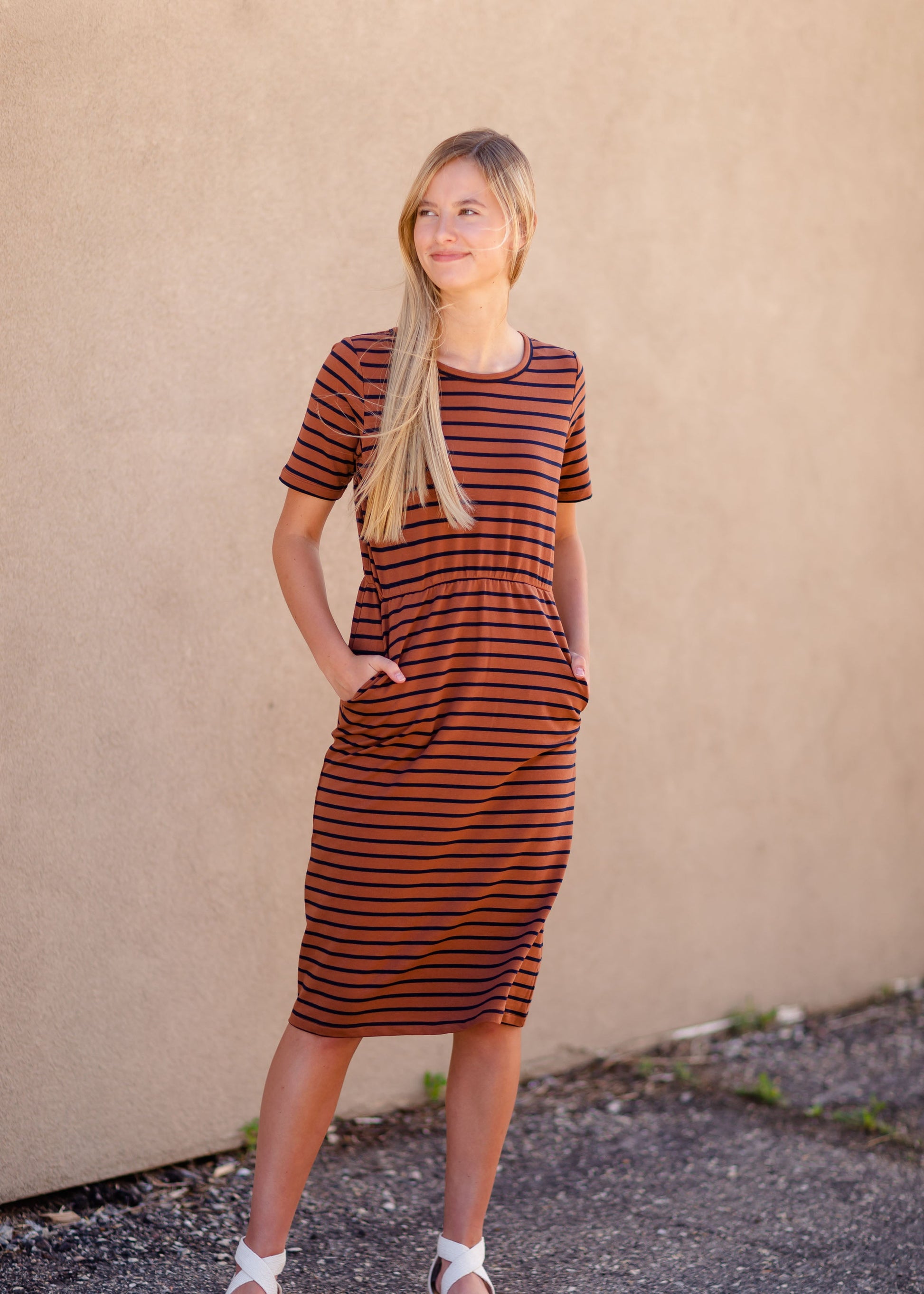 Meet Kristen. This Short sleeve Midi Dress was designed in-house and definitely isn't your typical cotton midi dress! This classic style is crafted with quality fabrics and needs no slip. The elastic waist and longer, short sleeves are extremely flattering and feminine. You will also love the placement of the two front pockets as well, this small patch style pocket hits just right!