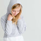 Girl wearing a french terry hoodie with a white button shirt underlay