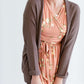 Woman wearing a lightweight knit cardigan in navy, taupe or cream. 