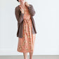 Woman wearing a lightweight knit cardigan in navy, taupe or cream. 