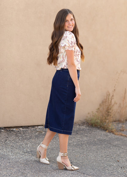 A dark blue denim midi skirt with contrast stitching and a side sip closure.