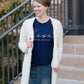 Young woman wearing a love is patient king james version bible verse graphic navy tee