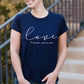 Young woman wearing a love is patient king james version bible verse graphic navy tee