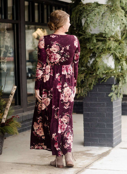 Woman wearing a burgandy floral maxi dress with sole society boots