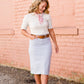 woman wearing a gray mock neck short sleeve top