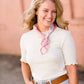 woman wearing a gray mock neck short sleeve top