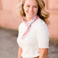 woman wearing a gray mock neck short sleeve top