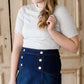 woman wearing a gray mock neck short sleeve top