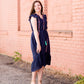 Navy midi dress with colorful embroidered accents 