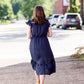 Navy midi dress with colorful embroidered accents 