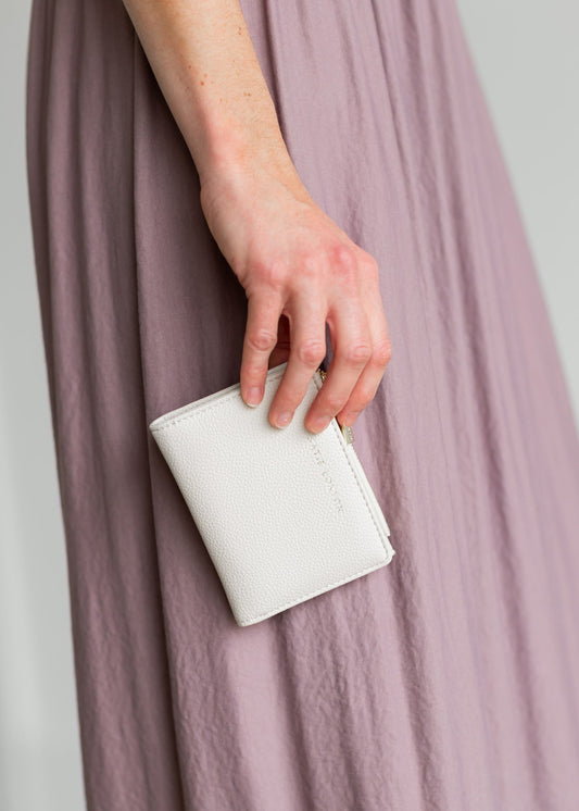 Nala Foldout Wallet with card slots, a zipper pocket, and gold lettering. Comes in ivory, olive, and tan.