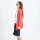 Woman wearing a green or coral waffle knit cardigan