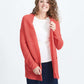 Woman wearing a green or coral waffle knit cardigan