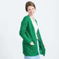 Woman wearing a green or coral waffle knit cardigan