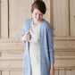 Woman wearing a green or coral waffle knit cardigan
